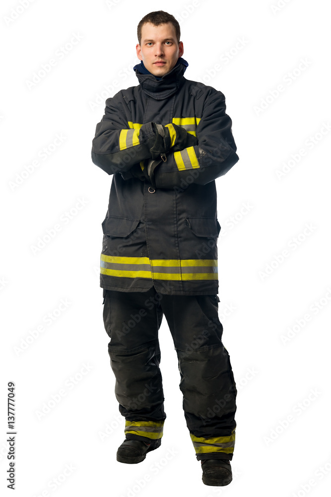 Fototapeta premium portrait of a young firefighter in dirty work clothes isolated on white background