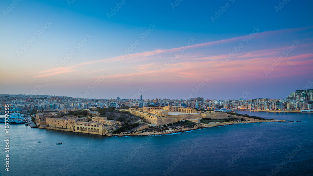 Valletta, Malta - Panoramic skyline view from the top of Valletta, the capital city of malta with Manoel Island and Sliema at sunset