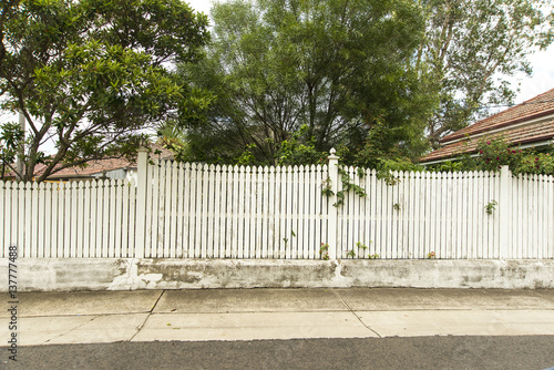White Picket fence in front of a house Copyspace.