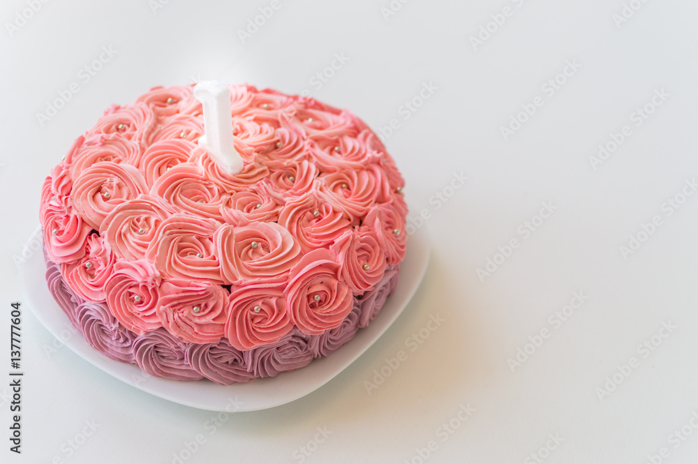 cake with a candle close-up of one year cake with a candle close-up of one year