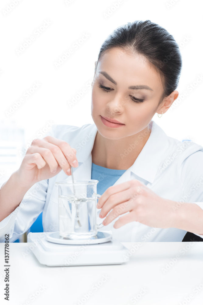 portrait of concentrated scientist working with chemical liquid in lab on white portrait of concentrated scientist working with chemical liquid in lab on white