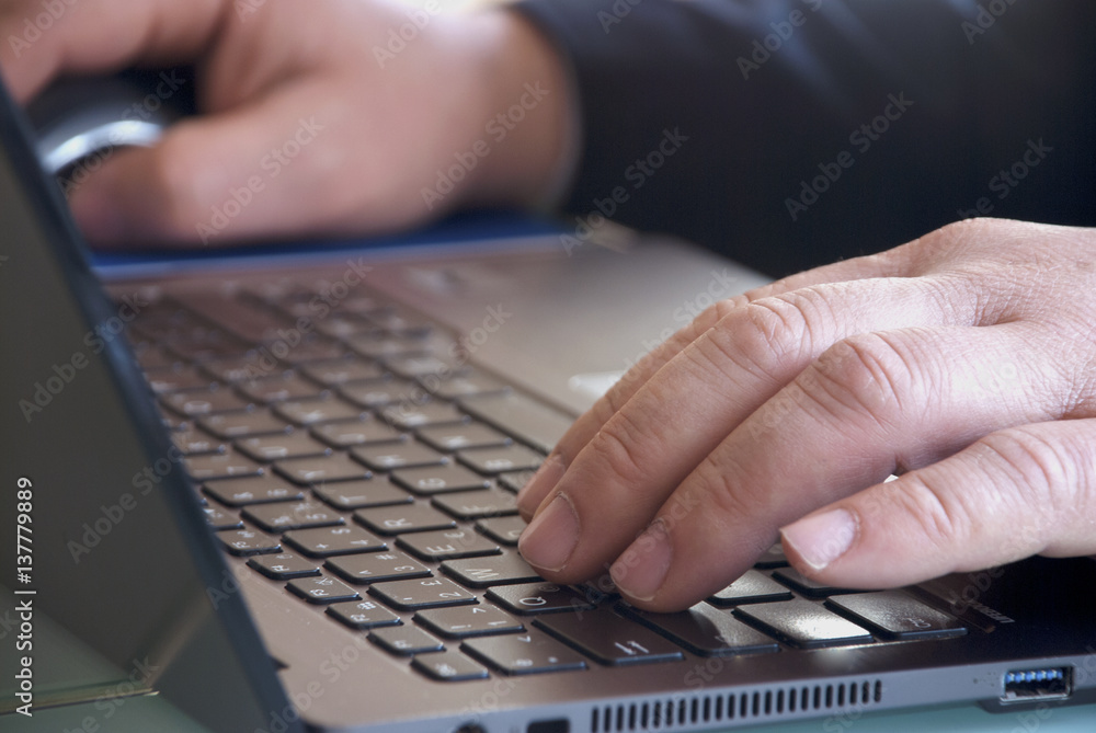 Businessman working and Close up on male hands typing on laptop keyboard Businessman working and Close up on male hands typing on laptop keyboard