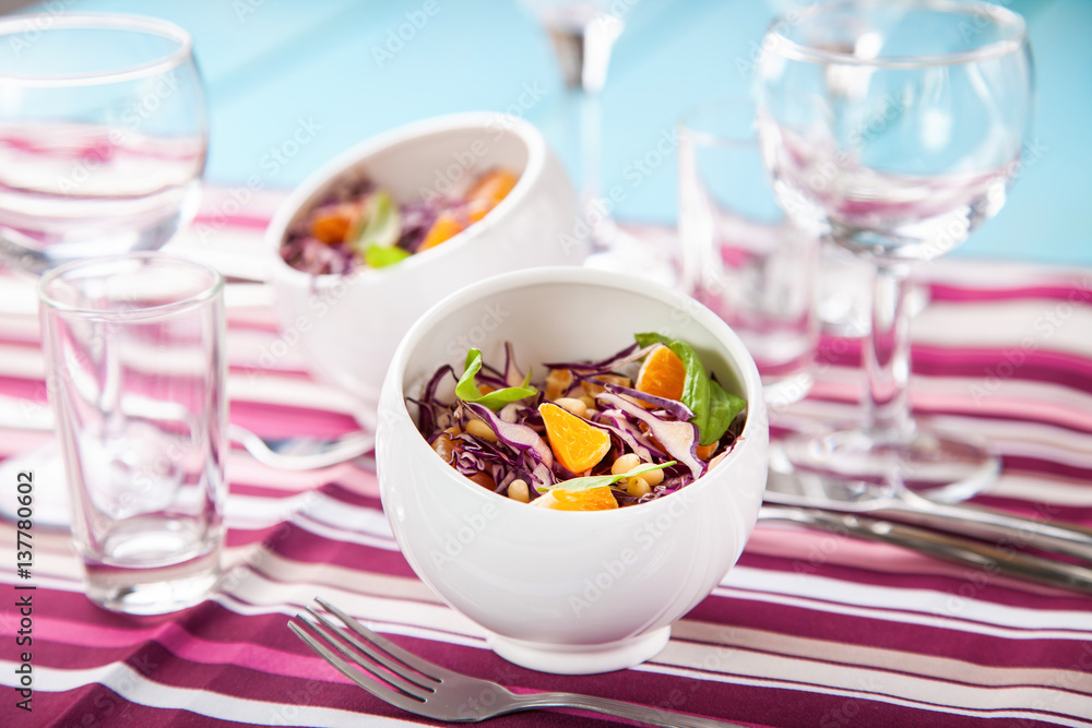 Red cabbage tangerines and pine nuts salad. Selective focus. Copy space. Red cabbage tangerines and pine nuts salad. Selective focus. Copy space.