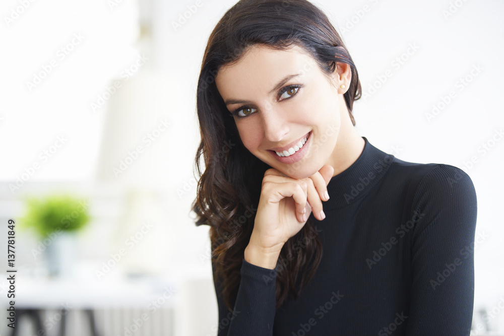 Confident businesswoman portrait. Close-up shot of a young brunette woman sitting at office. Confident businesswoman portrait. Close-up shot of a young brunette woman sitting at office.