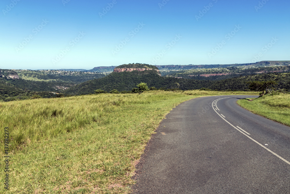 Rural Asphalt Road Curving Through Rural Landscape