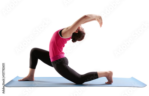 Sporty fit women practices yoga Anjaneyasana - low crescent lunge. photo