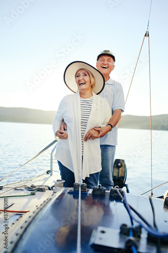 Laughing couple having romantic voyage on yacht