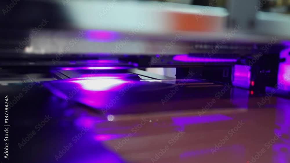 UV printing machine in action, close up at machine head UV printing machine in action, close up at machine head