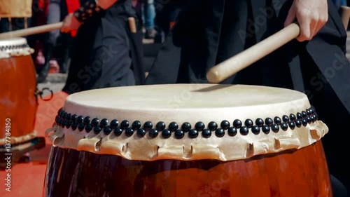 Musicians drummers play taiko drums chu-daiko outdoors. Culture folk music of Asia Korea, Japan, China.
