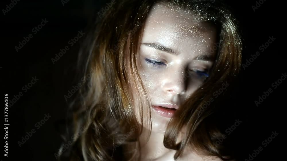 Portrait of a gorgeous girl with a decoration on the head in the shape of a crown. Long hair. In a Studio on a dark background Portrait of a gorgeous girl with a decoration on the head in the shape of a crown. Long hair. In a Studio on a dark background