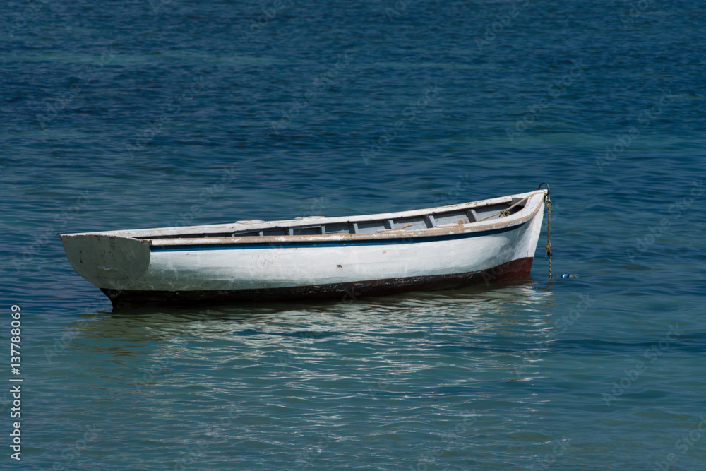 White pirogue - wooden boat at sea - Mauritius