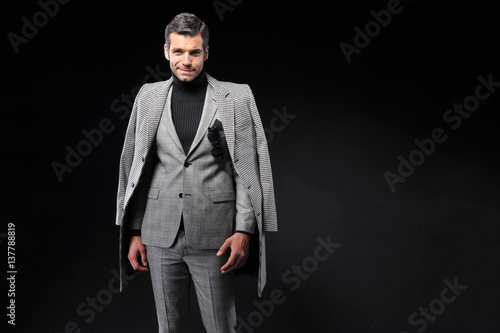 young business man wear suit on black background
