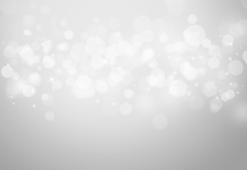 Grey sparkles glitter and rays lights bokeh abstract holiday background/texture.