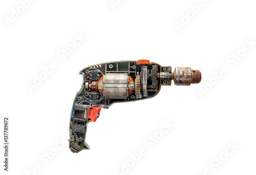 Disassembled electric drill isolated on white background, opened cover showing detail components inside with motor, gears and switch.