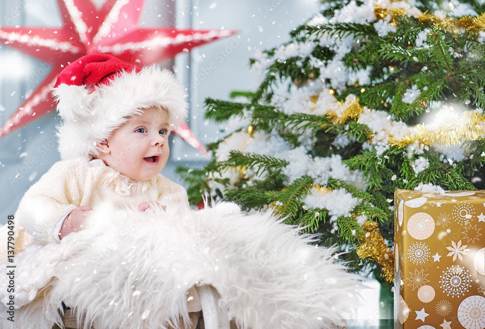 Cute boy sitting in the Christmas basket Cute boy sitting in the Christmas basket