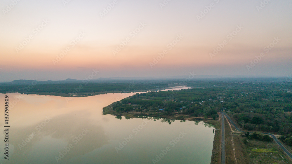 arial View of country with mountain at twilight sky. - drone camera.
Beautiful lake against mountain background.