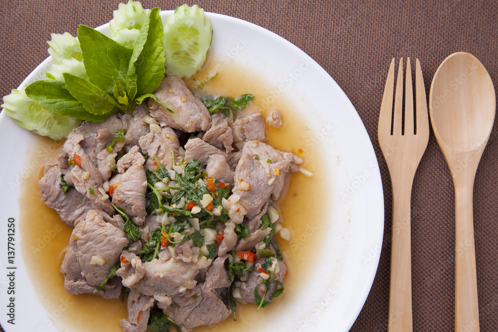 Closeup pork stir fried with basil leaves in white dish Closeup pork stir fried with basil leaves in white dish
