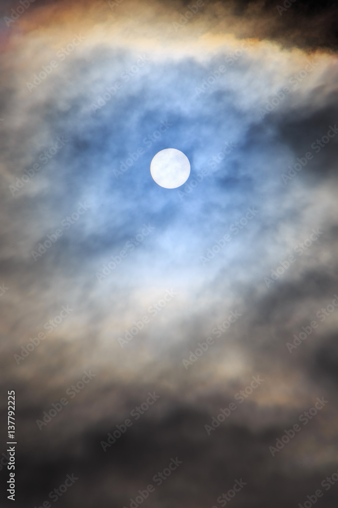 view on sun hidden behind clouds view on sun hidden behind clouds