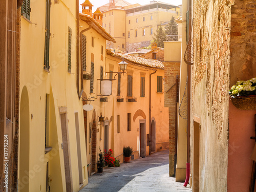 Beautiful narrow alley with traditional historic houses at Pienza city © rolandbarat