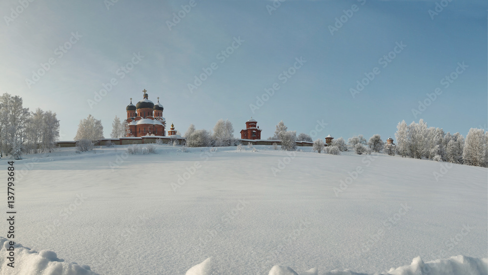 Orthodox monastery amidst hoary forest in deep snow area