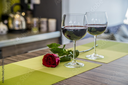 Valentines day: glasses of vine, red roses, for romantic evening