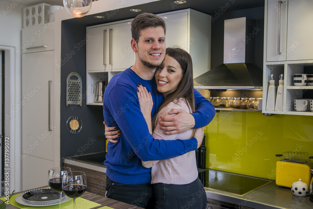 Couple sharing affectionate moment. Happy couple drinking vine and spending time together at home. Couple in love hugging Couple sharing affectionate moment. Happy couple drinking vine and spending time together at home. Couple in love hugging