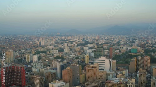 Lima Peru Aerial v64 Flying over Miraflores panning with cityscape views at sunset. photo