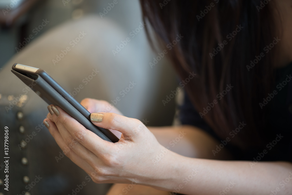 Asian woman holding smart phone