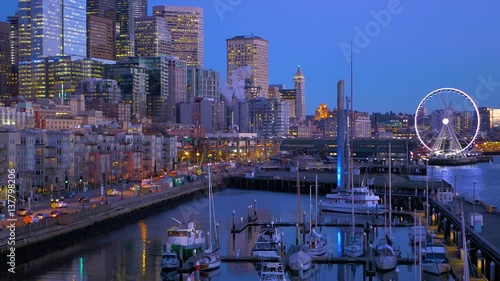 Seattle, WA - January 30, 2017. The light of downtown Seattle at night. Port of Seattle. Skyscrapers on a background of blue sky. Pier 66. City landscape video. 4K, 3840*2160, high bit rate, UHD