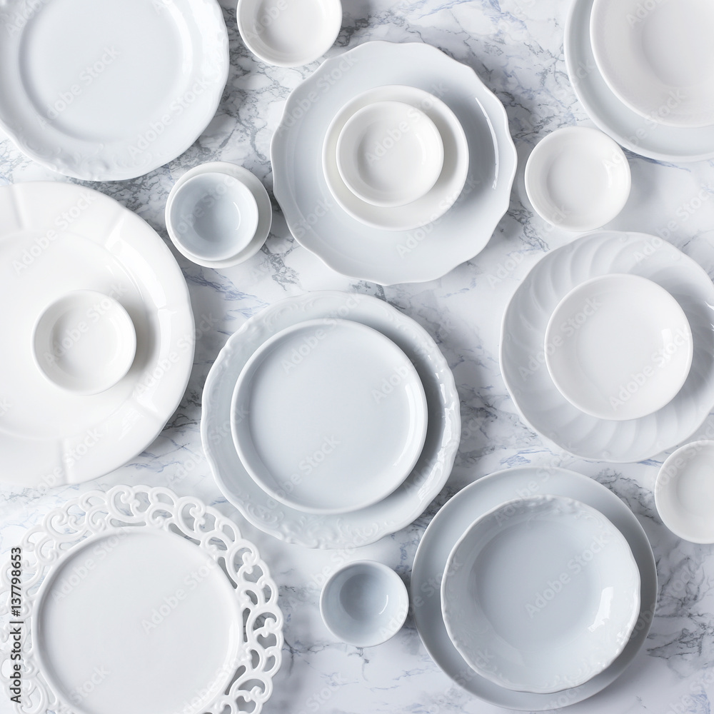 White plates on marble table White plates on marble table