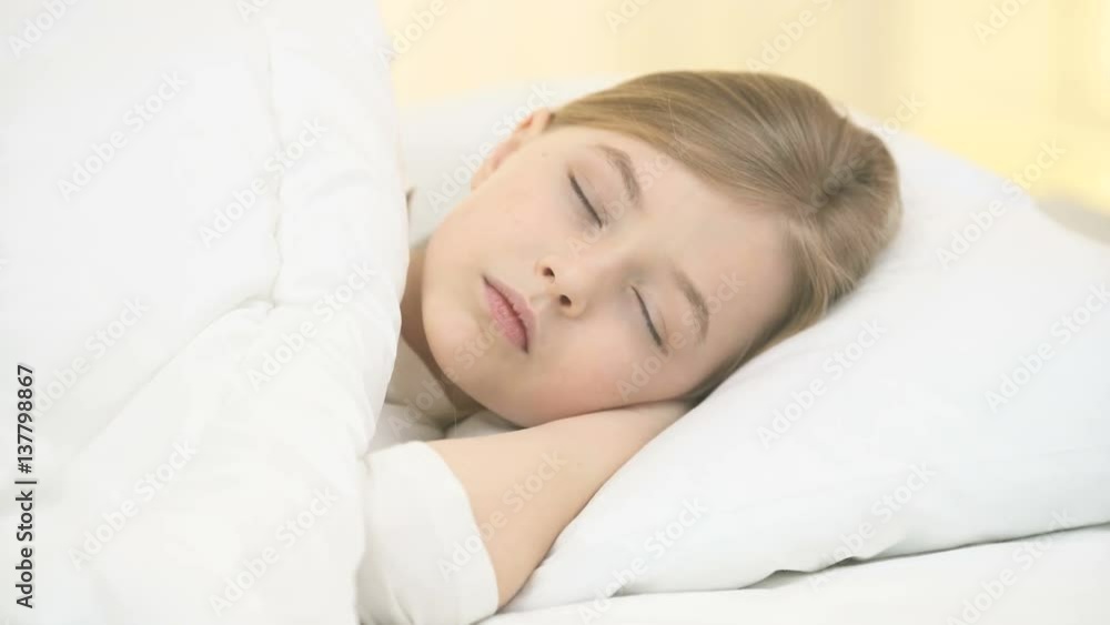 The young girl lay on the bed and smile The young girl lay on the bed and smile