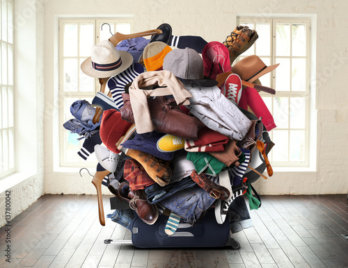 Big heap of different clothes and shoes photo