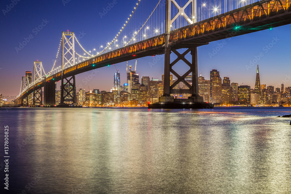 San Francisco skyline with Oakland Bay Bridge at night, California, USA