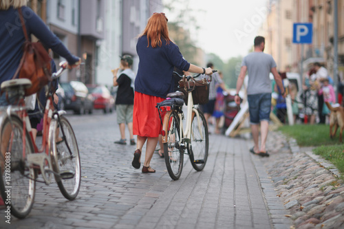 Women with bicycles arrived at a street party