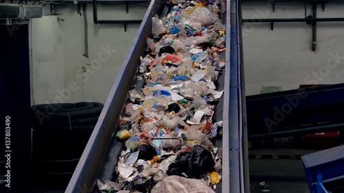 Trash conveyor working at a trash recycling plant. 4K.