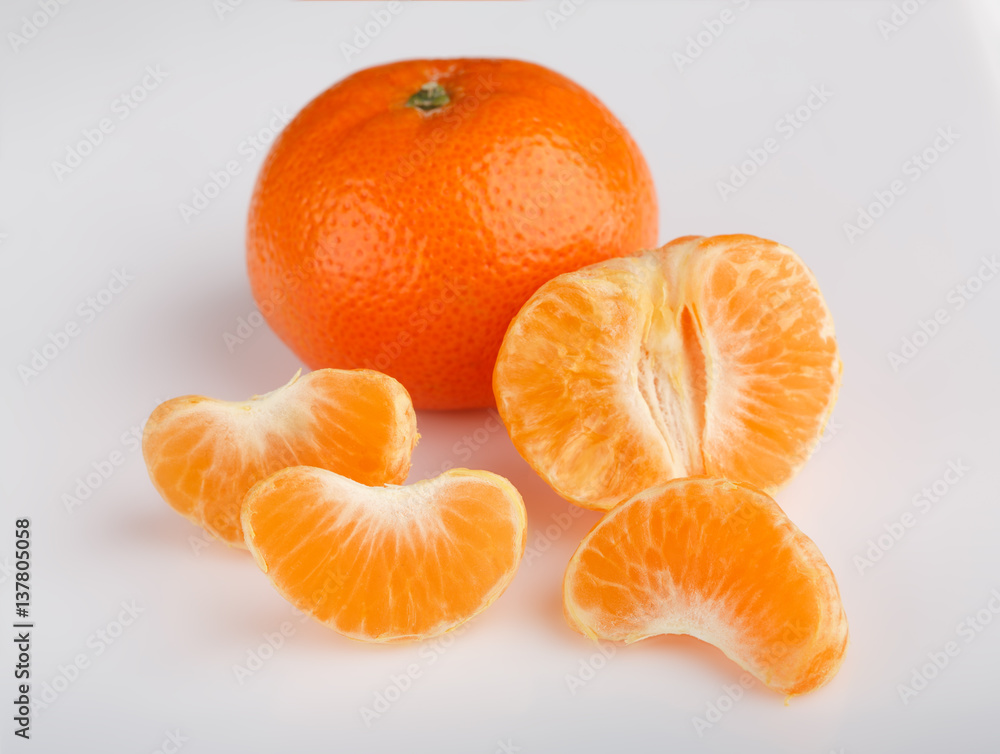 Ripe mandarin close-up on a white background. Tangerine orange. Colorful Food and drink still life concept. Fresh fruits and vegetables on color background. Clementine. Citrus. Fresh fruits. Diet. Ripe mandarin close-up on a white background. Tangerine orange. Colorful Food and drink still life concept. Fresh fruits and vegetables on color background. Clementine. Citrus. Fresh fruits. Diet.