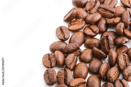 roasted coffee beans isolated in white background. Roasted coffee beans background close up. Coffee beans pile from top on white background with copy space for text. Good morning.