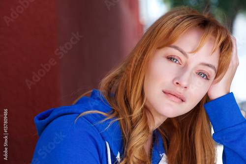 young woman in contemplation leaning head on hand