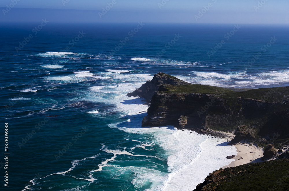 Rock Cliff Blue Sea Waves and a High Mountain. South Africa.