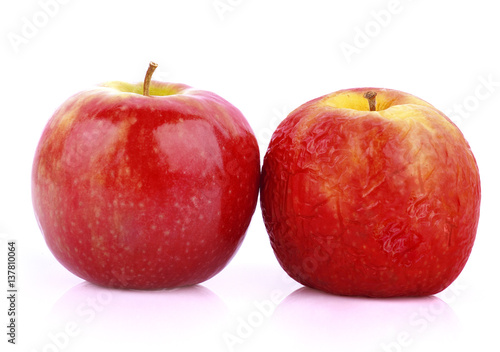 Ripe and rotten apple on a white background