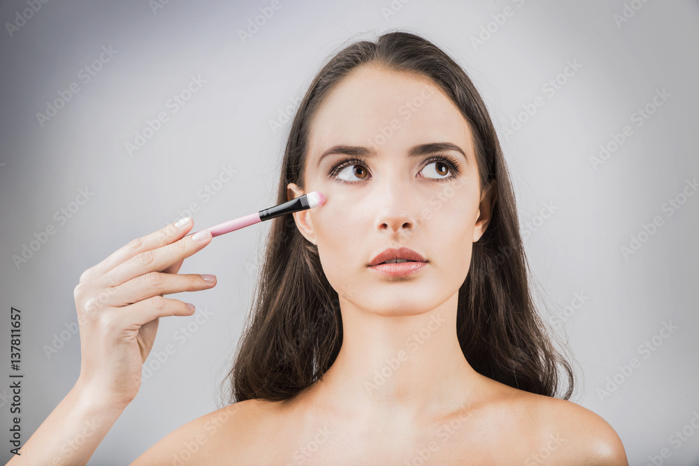 © de Art - Beauty portrait of young, attractive, fresh, healthy and natural woman with the makeup brush © de Art - Beauty portrait of young, attractive, fresh, healthy and natural woman with the makeup brush