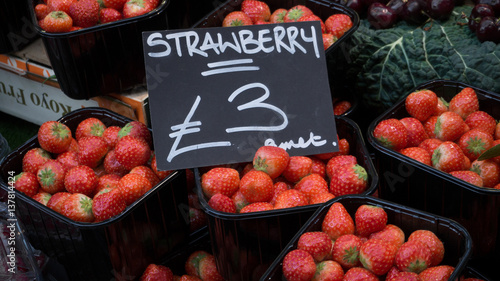 boxes of strawberries sell in the market
