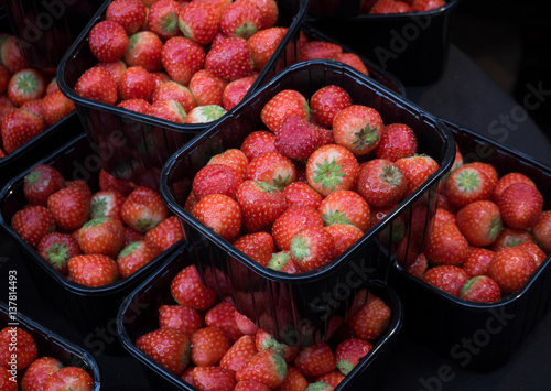 boxes of strawberries sell in the market