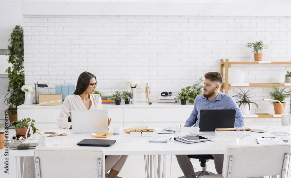Businessman and Businesswoman Working Together at Office Businessman and Businesswoman Working Together at Office
