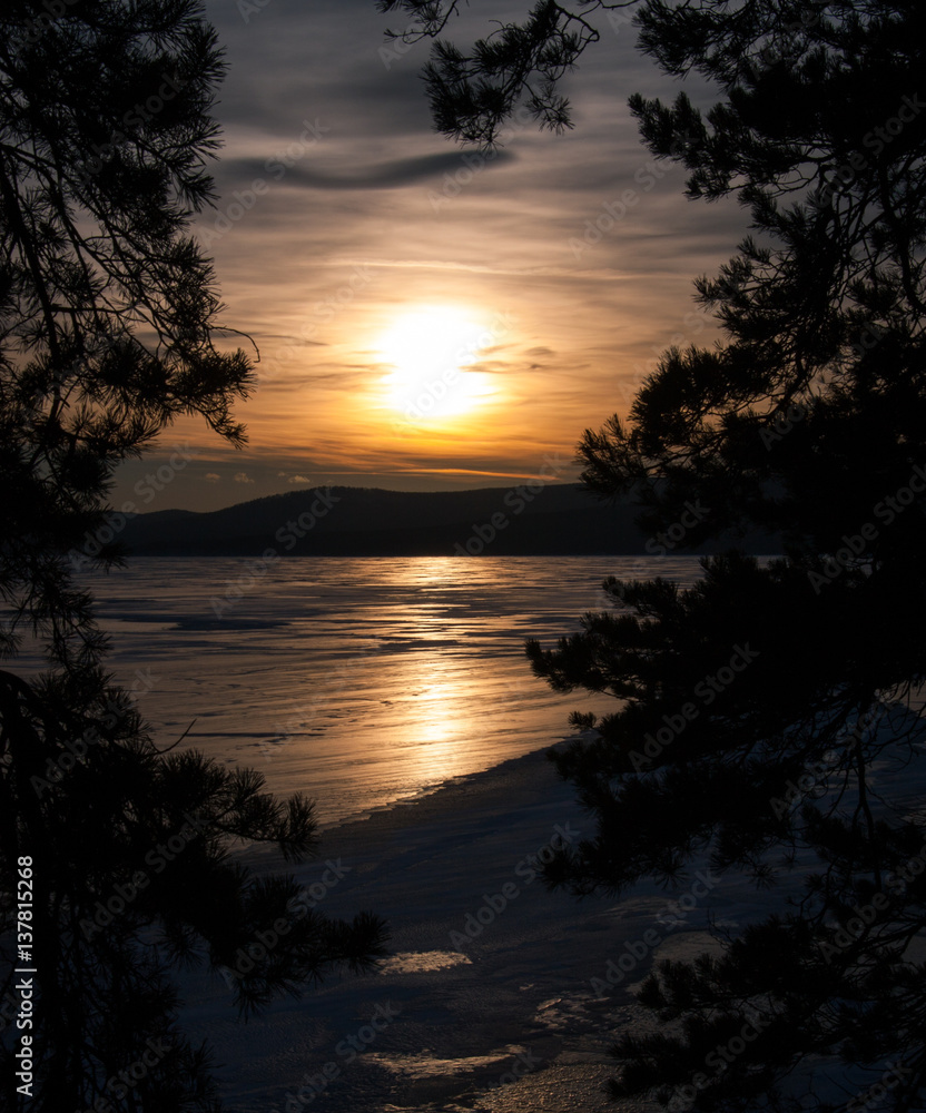 Sunset on the ice lake