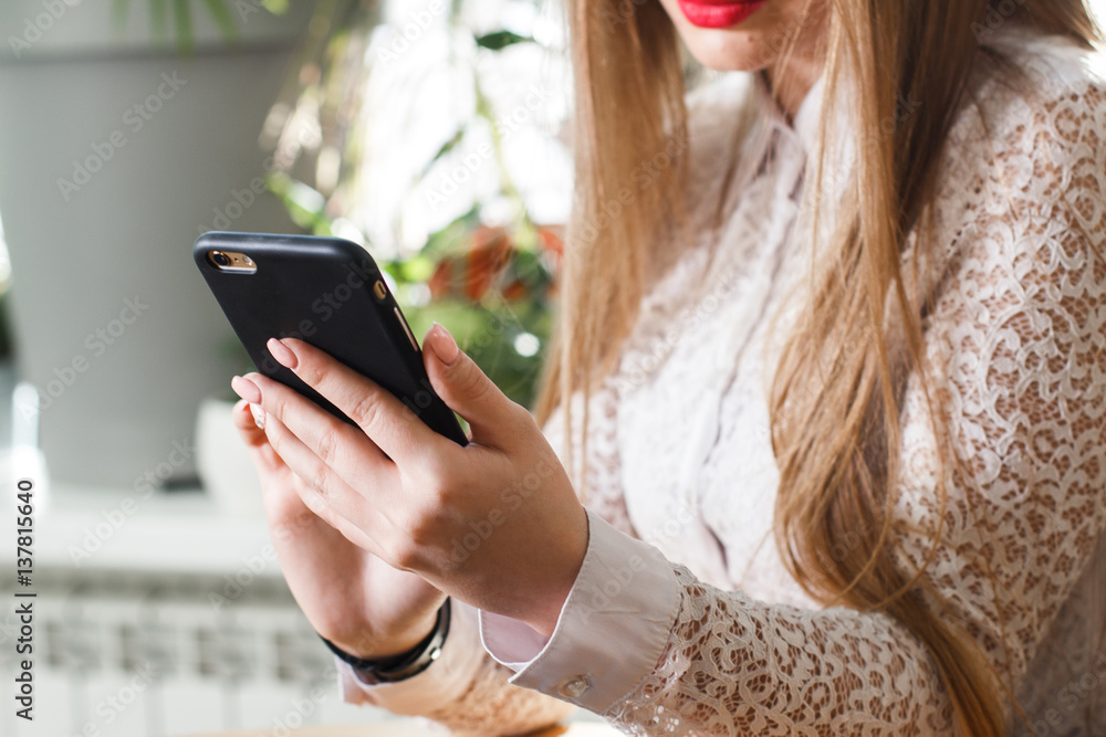 Woman using mobile phone and laptop at home. Woman using mobile phone and laptop at home.