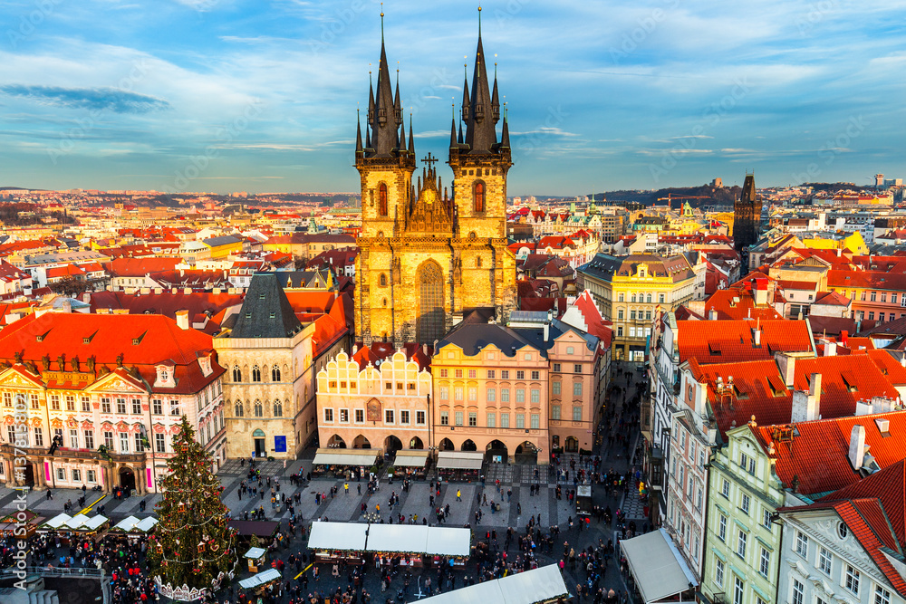 Obraz premium Old Town of Prague, Czech Republic. View on Tyn Church and Jan Hus Memorial on the square as seen from Old Town City Hall. Blue sunny sky