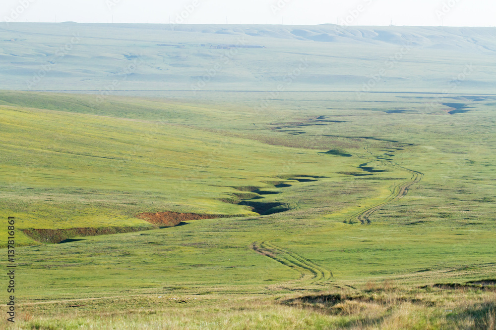 Steppe with breakages, track and hills, Republic of Kalmykia, Russia 
