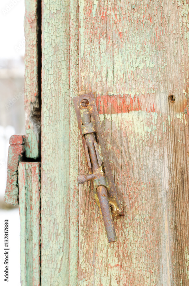 old deadbolt or latch on a wooden door old deadbolt or latch on a wooden door