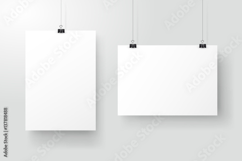 White posters hanging on binder. Grey wall with mock up empty paper blank. Layout mockup. Vertical and horizontal template sheet.